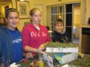 Adelina, Meredith, and Gilad with their awesome Sukkah! 